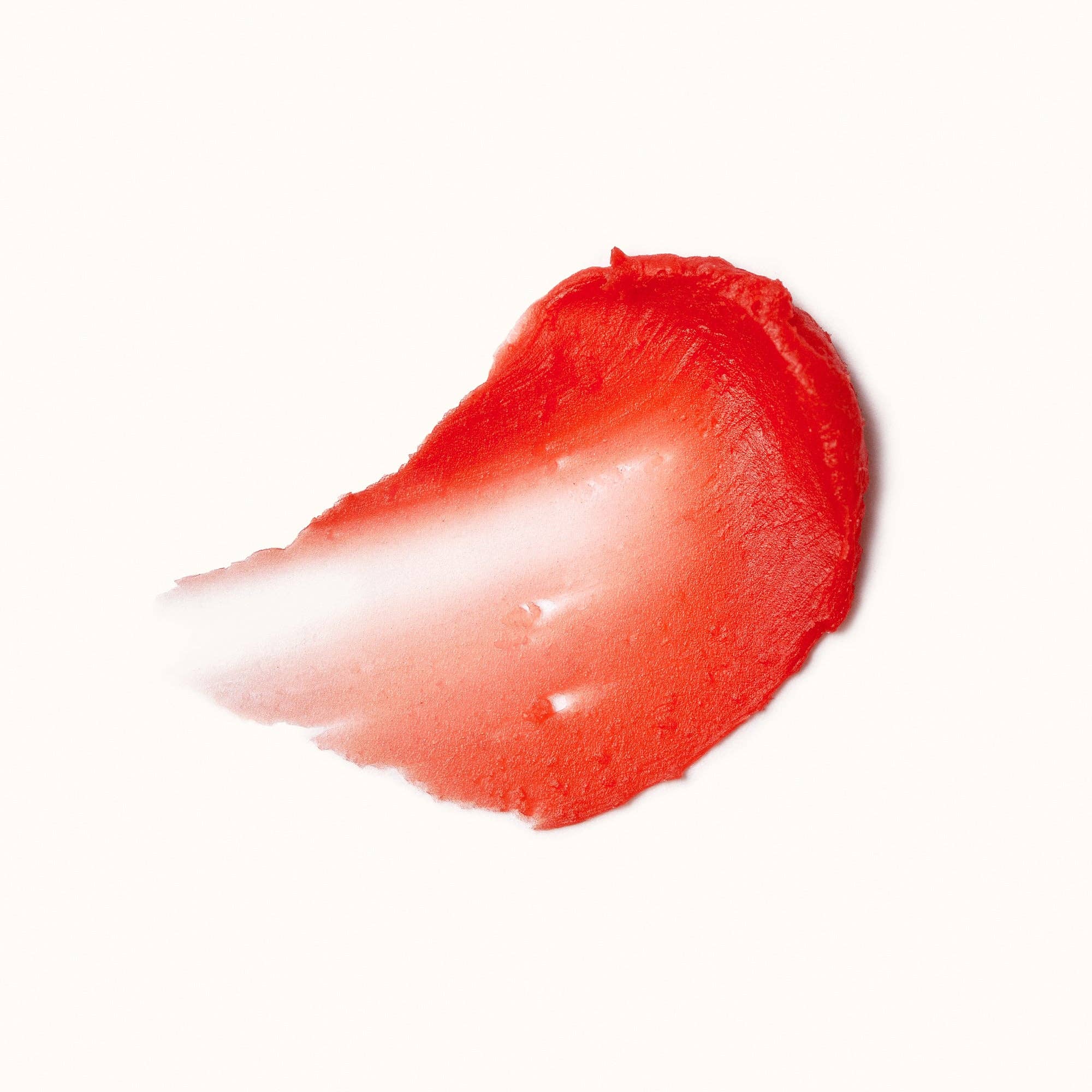 Close-up of a red lipstick swatch on a white background