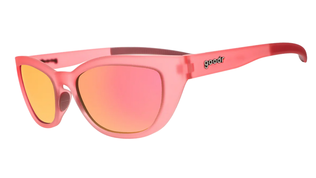 Pink sunglasses with yellow lenses on a white background