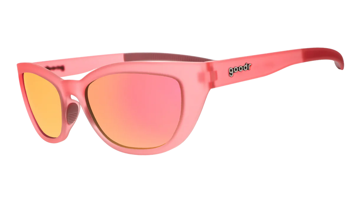 Pink sunglasses with yellow lenses on a white background